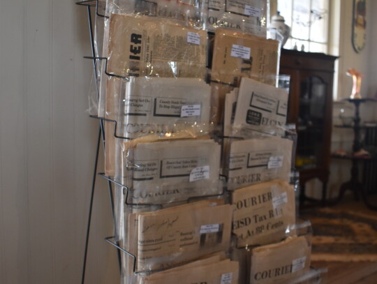 Items being sold at McDade Antiques and Marketplace in McDade include old newspapers, seen here on display during the grand opening April 1. Photo by Fernando Castro