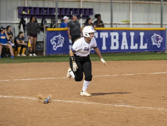 Paiton Altmiller taking off to first base after smacking a ball into the outfield. Photo by Erin Anderson