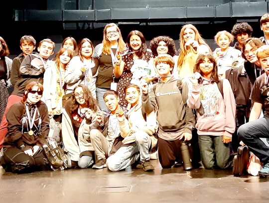 Teacher Katie Brock (top center) and her group of Elgin Middle School theatre actors celebrate their awards at the One Act Play Festival at the Bastrop Performing Arts Center April 6. Courtesy photo