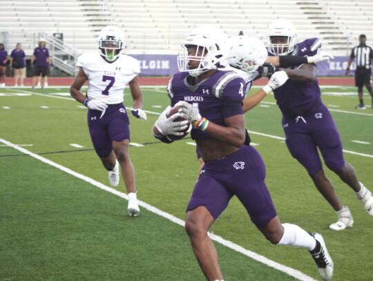 Wildcats senior running back Curtis McFarlin (4) makes his next move with the ball while fellow senior linebacker Derrius Holiday (7) closes in to make a tackle downfield. Photo by Andrew Salmi