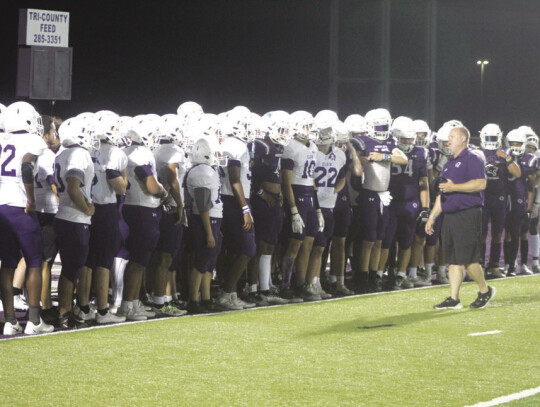 Elgin High School varsity football head coach Heath Clawson talks to his players on Friday, May 19 following the team’s spring football scrimmage held at Wildcat Stadium. Photo by Andrew Salmi