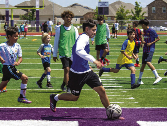 Young Elgin athletes scrimmage against each other on June 8 during the Wildcats Youth Soccer Camp hosted at Wildcat Stadium. Photo by Erin Anderson