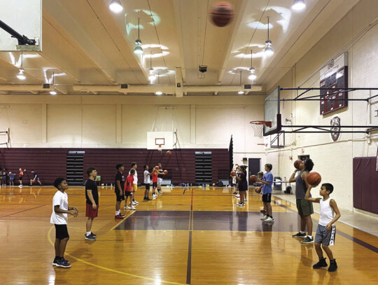 Campers line up across from one another for a passing drill on June 22 during the Bastrop Bears boys youth basketball camp held at Bastrop High School. Photo courtesy of Eric Woods