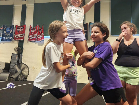 A few Elgin youth cheerleaders practice stunting together at Cheer Skills Academy in Taylor. Photo courtesy of Amanda Harvey