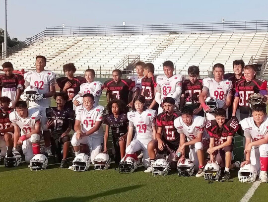 The Elgin 13U tackle football team and the 13U Chengdu Crimson Tide Eagles take a photo together on July 21 following their game held in Round Rock. Photo courtesy of Amanda Harvey