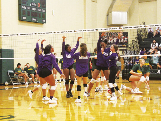 The Elgin High School varsity volleyball team celebrates on Aug. 5 during a Lady Wildcats scrimmage against Academy High School held in Taylor. Photo by Andrew Salmi
