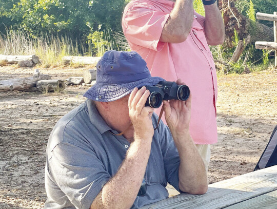 Steve Moredock and Luke Thompson spy some of the many black vultures and turkey vultures out in the morning sun. Photos by Niko Demetriou