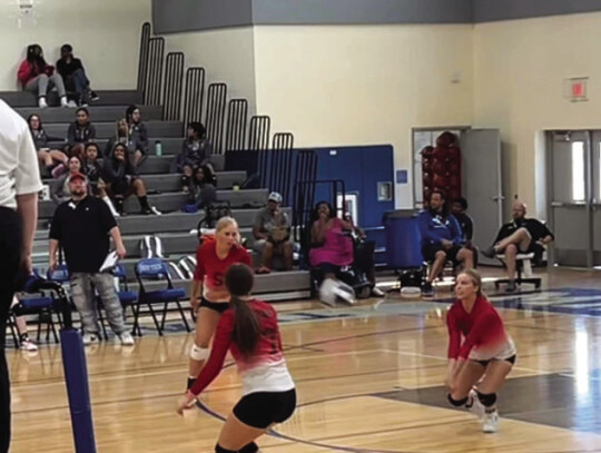 McDade varsity volleyball swarms around the ball on Aug. 15 during a Lady Bulldogs’ road match at Manor New Tech. Photo courtesy of Aaron Hallford