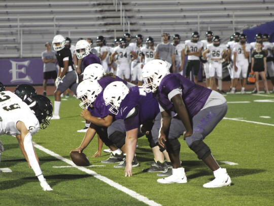 The Wildcats varsity football offensive line gets ready for the snap on Aug. 18 during Elgin’s home scrimmage vs. Canyon Lake at Wildcat Stadium. Photo by Andrew Salmi