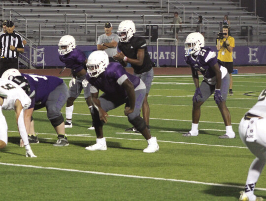 Wildcats varsity football senior quarterback Nathen Lewis and his teammates get set offensively on Aug. 18 during Elgin’s home scrimmage vs. Canyon Lake. Photo by Andrew Salmi