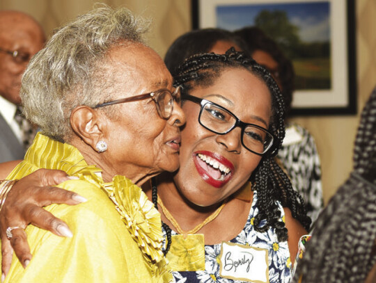 Viola Faye Reese Goodman (left) is congratulated for being one of the unsung African American heroes in Bastrop County. Photo courtesy of Larry Nix