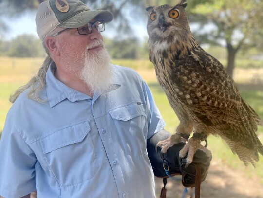 Event photographer Larry Grabinski is close with Eurasian eagle owl, Cyrene, the largest owl breed by weight in the world. Photo by Niko Demetriou