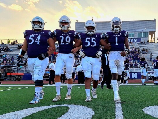 The Elgin High School varsity football captains take the field on Sept. 1 prior to the Wildcats’ home game vs. Austin Akins High School. From left to right: senior Hunter Gibson, junior Jackson Clowdus, senior Dennis Lavigne and senior Nathen Lewis. Photo by Marcial Guajardo 