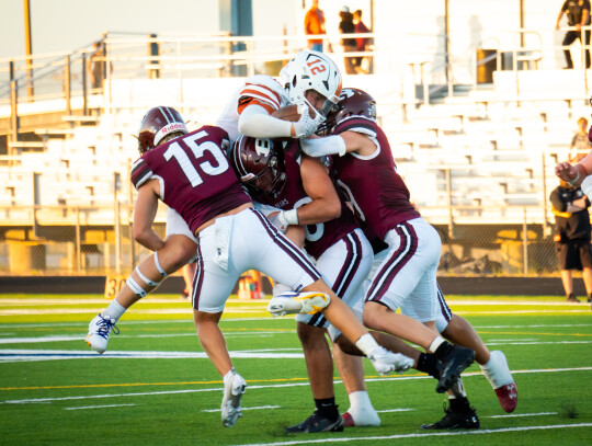 The Bears varsity football team’s defense swarms an opposing ball carrier on Sept. 8 during Bastrop’s home game vs. Westwood. Photo by Chris White of Bastrop ISD