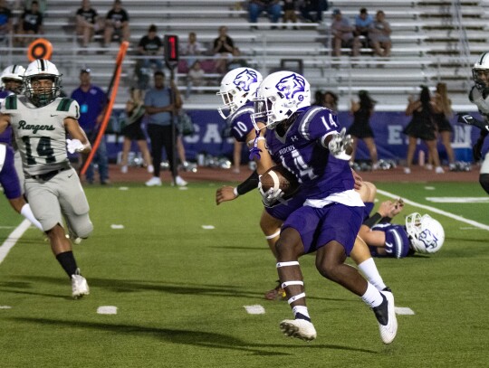 Elgin varsity football sophomore wide receiver Gary Jefferson Jr. (14) gains extra yardage after the catch on Sept. 8 during the Wildcats’ home game against Rudder. Photo by Marcial Guajardo