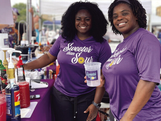 Sweeter Than Sour’s Michaela Davis and Tiffany Thompson serving a line of thirsty fairgoers.