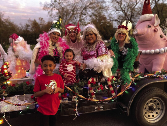 Brothers RJ Williams (left) and Kai Tee Garza hang out with the Elgin Sowpremes before the lighted Christmas parade Saturday. Courtesy photo