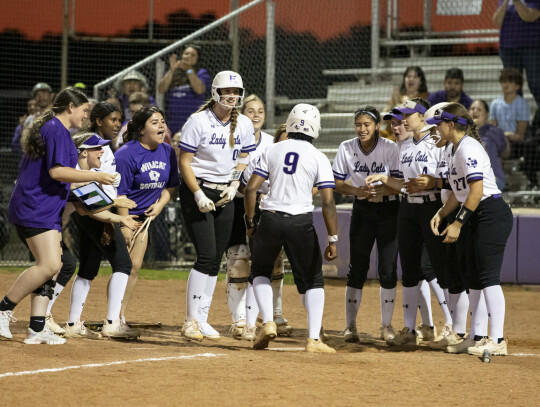 Elgin High School varsity softball celebrates a home run by Jaylan Roberson during the Lady Wildcats’ victory at home March 24 over Pflugerville High School. Photo by Erin Anderson