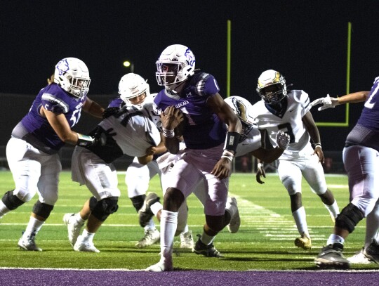 Elgin High School varsity football senior quarterback Nathen Lewis follows blocks from his offensive line and scores a rushing touchdown Sept. 1 during the Wildcats’ dominant 47-0 home victory versus Austin Akins High School. Photo by Marcial Guajardo