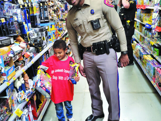 Roland Daniels grabbing a few action figures with trooper Greg Jordan. Photo courtesy Elgin Juneteenth Organization