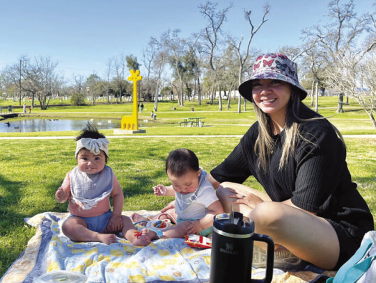 Camila, Noah and Julie in front of “Gigaffe,” the park’s big, yellow installment by artist Jeffie Brewer. Photo by Niko Demetriou