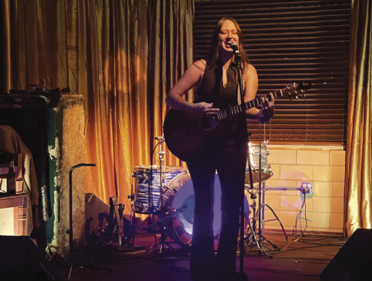 JustHannah performs some originals during the MCB fundraiser at Lightnin’ Bar, March1. The singer/songwriter moved to Elgin in 2018 from Arizona. “Elgin is my home now. It’s been just such a blessing, meeting all these amazing people,” she said. Photo by Niko Demetriou 